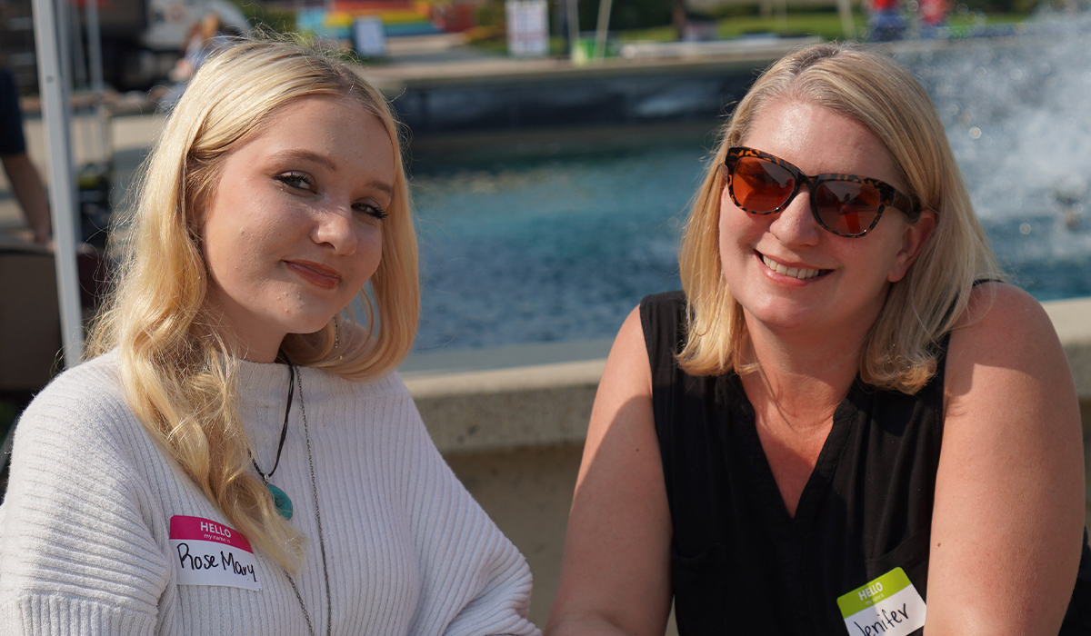 Two women attending WVC's new student orientation smile at the camera