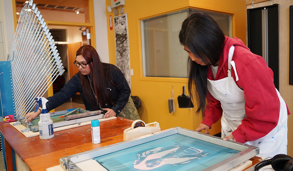 Two WVC students work on their printmaking projects.