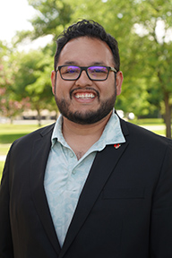 Portrait of Frank Sarmiento-Torres standing outside. 